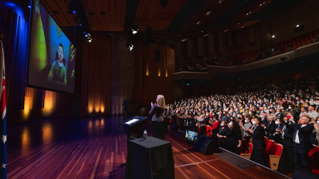 Pictured: President Zelenskyy receiving a standing ovation from the audience in Llewellyn Hall during his address to Australian students on Wednesday 3 August. The President appears via livestream through a screen on stage.