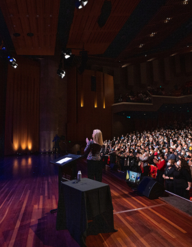 Pictured: President Zelenskyy receiving a standing ovation from the audience in Llewellyn Hall during his address to Australian students on Wednesday 3 August. The President appears via livestream through a screen on stage.