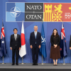 Image of NATO world leaders standing together with country flags